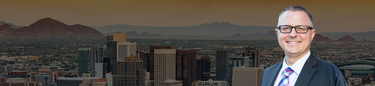 Attorney Trent R. Buckallew in front of a vibrant cityscape